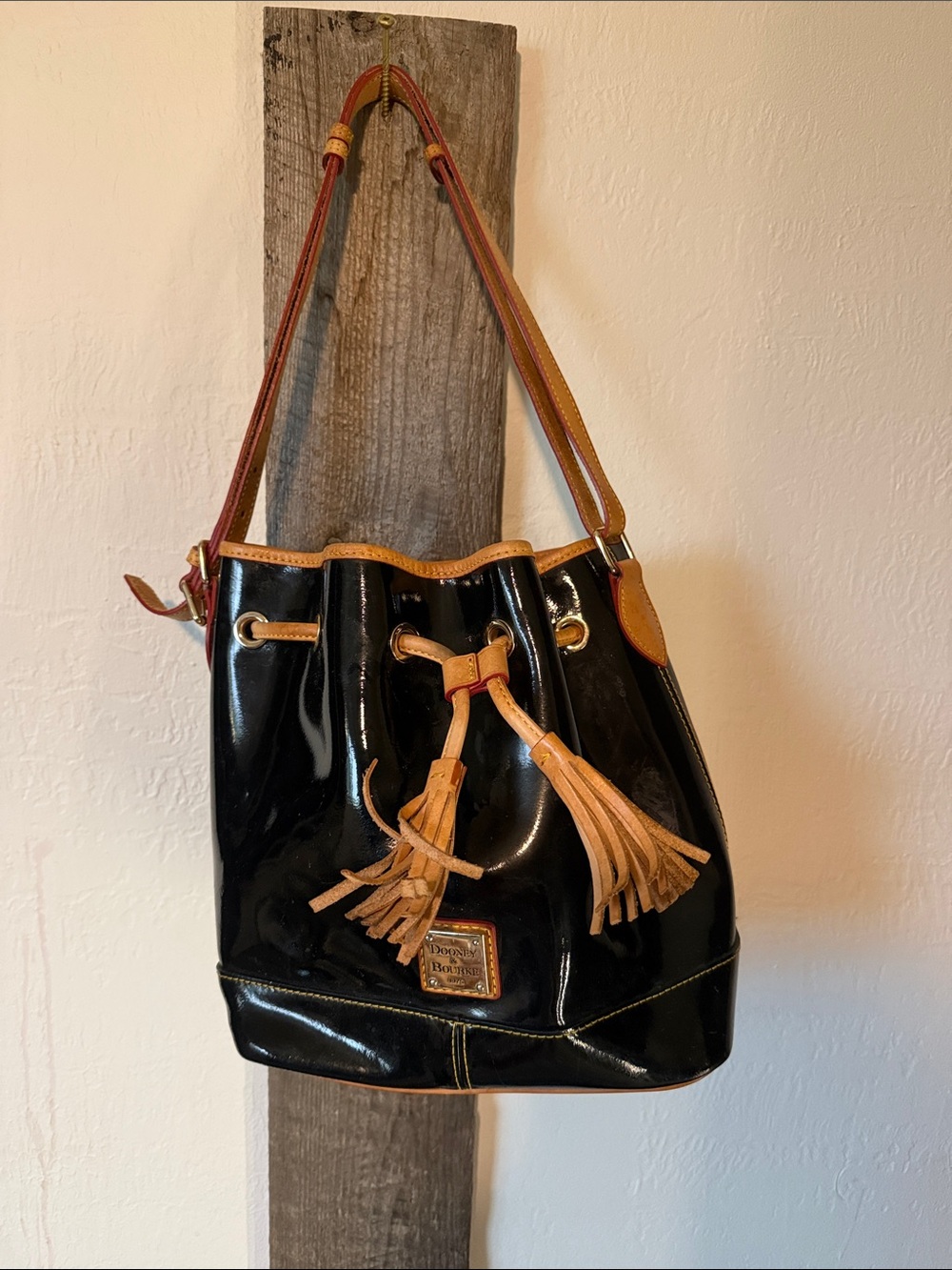 Dooney & Bourke Black Patent Leather Drawstring Shoulder Bag with Tan Trim